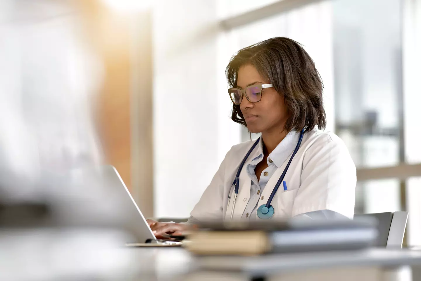 physician diligently working at a laptop